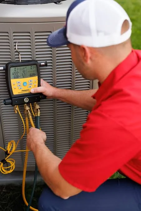 Technician examining diagnostic readings on a digital HVAC service instrument